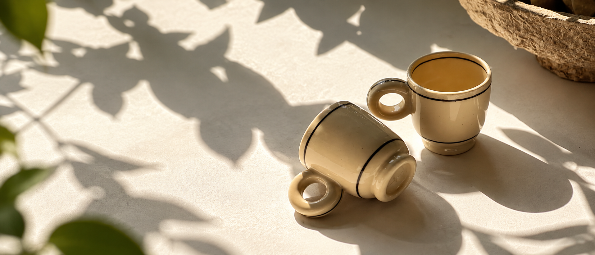 Tableware and drinkware arranged in a warm everyday setting